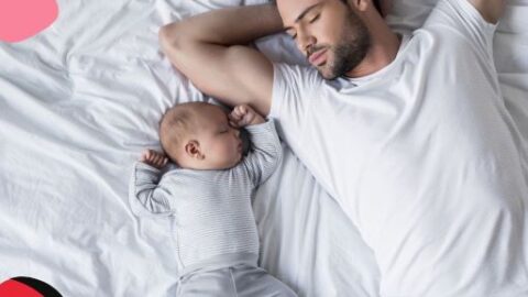 Paternity leave changes with dad on bed with newborn