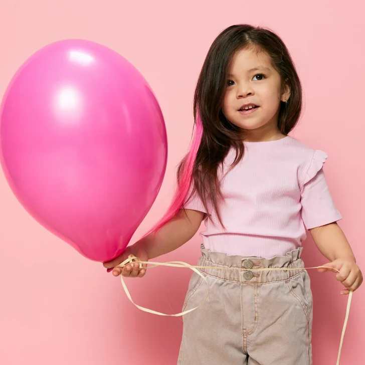 little girl with pink balloon