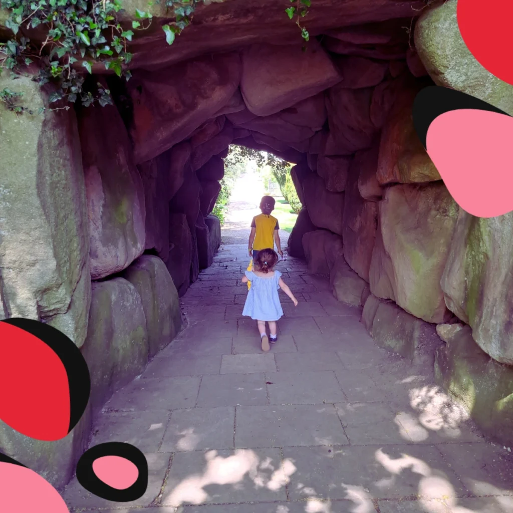 two children walking through the garden caves at thornbridge hall derbyshire