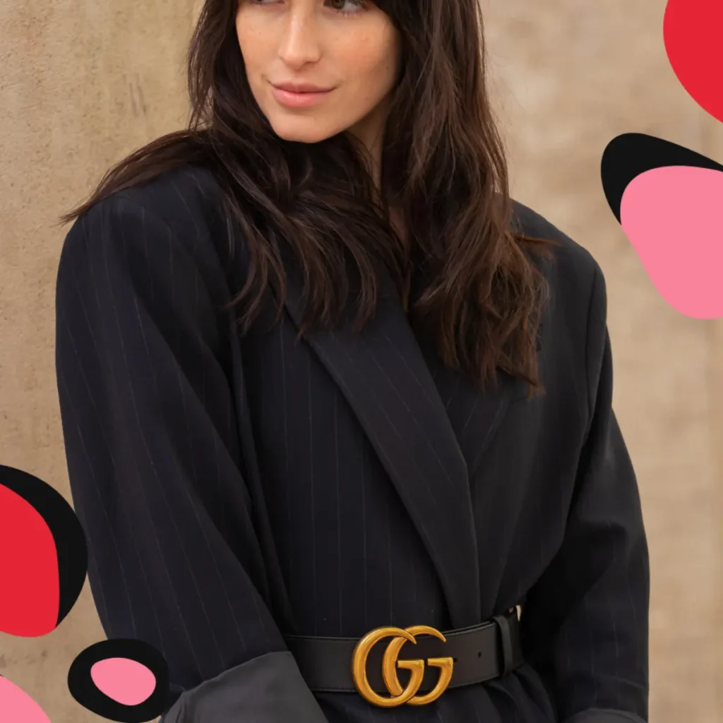 woman wearing a oversized blue jacket with a gucci belt