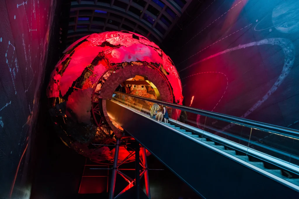london science museum with escalator heading up to the planets