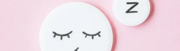 circles with sleepy faces on pink background