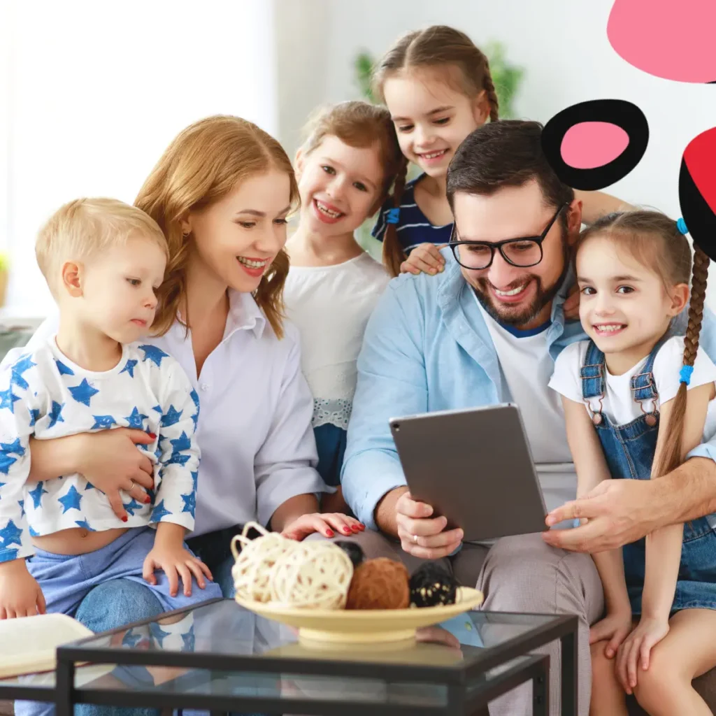 large family on sofa looking at Tips For Managing Debt In Large Families