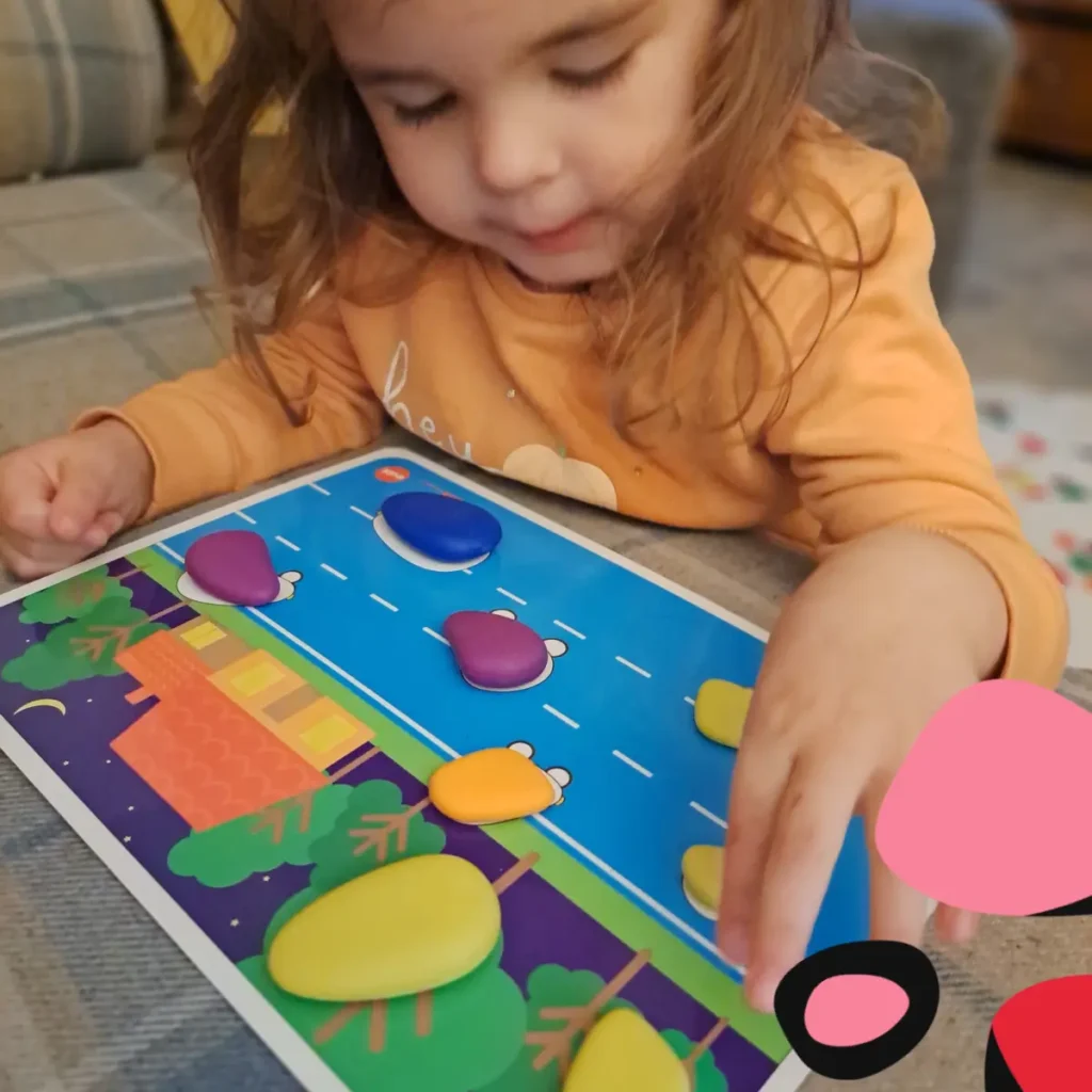 little girl playing a shape sorting game game for an example of Cognitive Activities for Infants