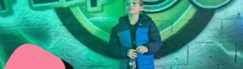 picture of young boy stood in front of the flip out liverpool soft play sign