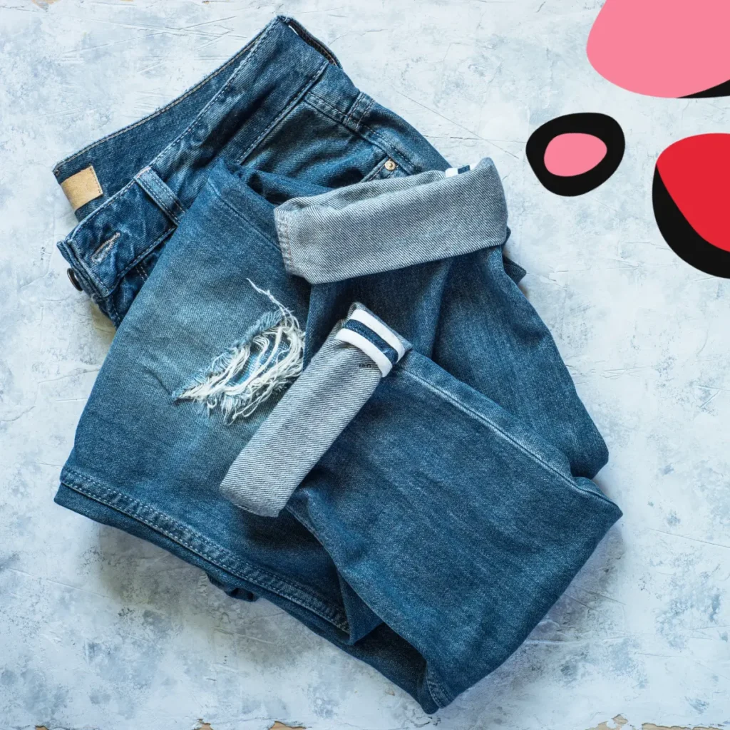 folded jeans on a blue background