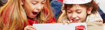 two girls 6yrs to 12 yrs christmas gift guides looking at a christmas gifts