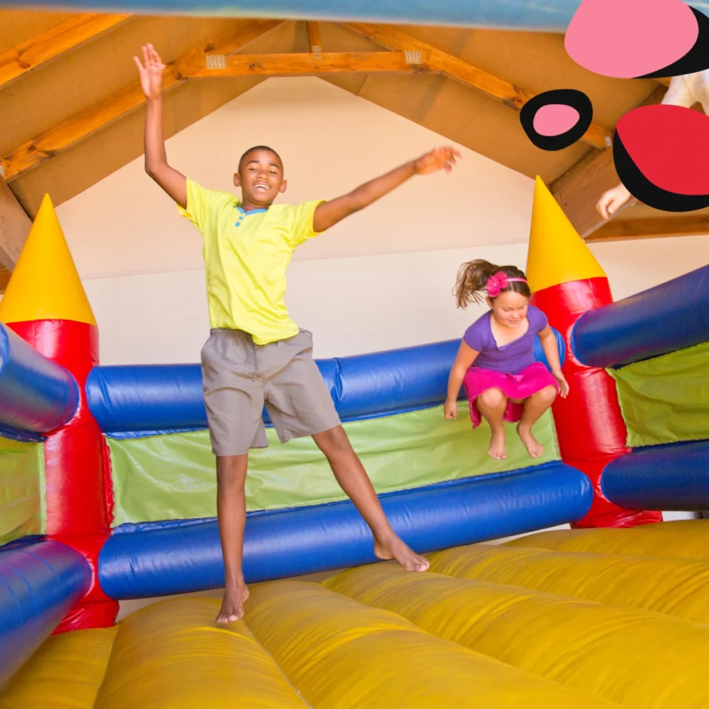 kids bouncing on an inflatable bouncy castle for a birthday party