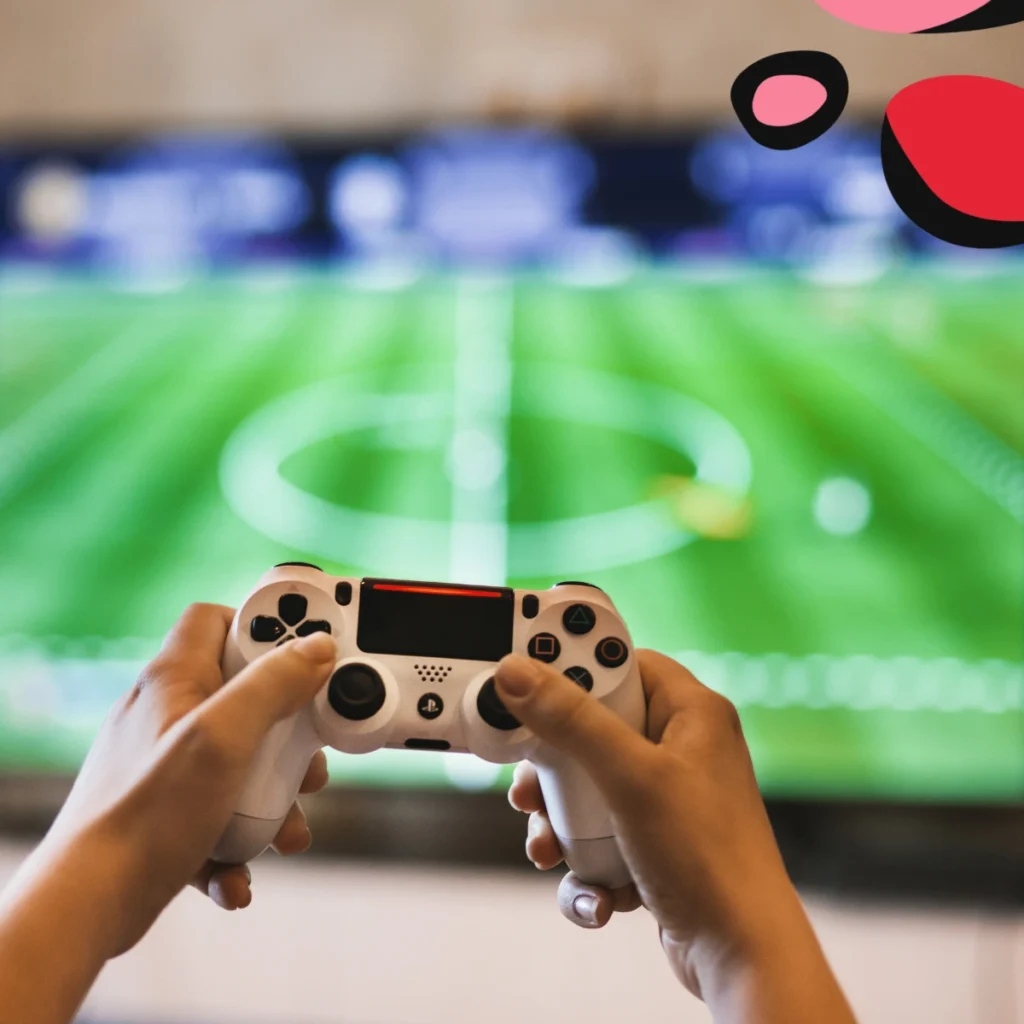child holding up ps4 controller playing fifa
