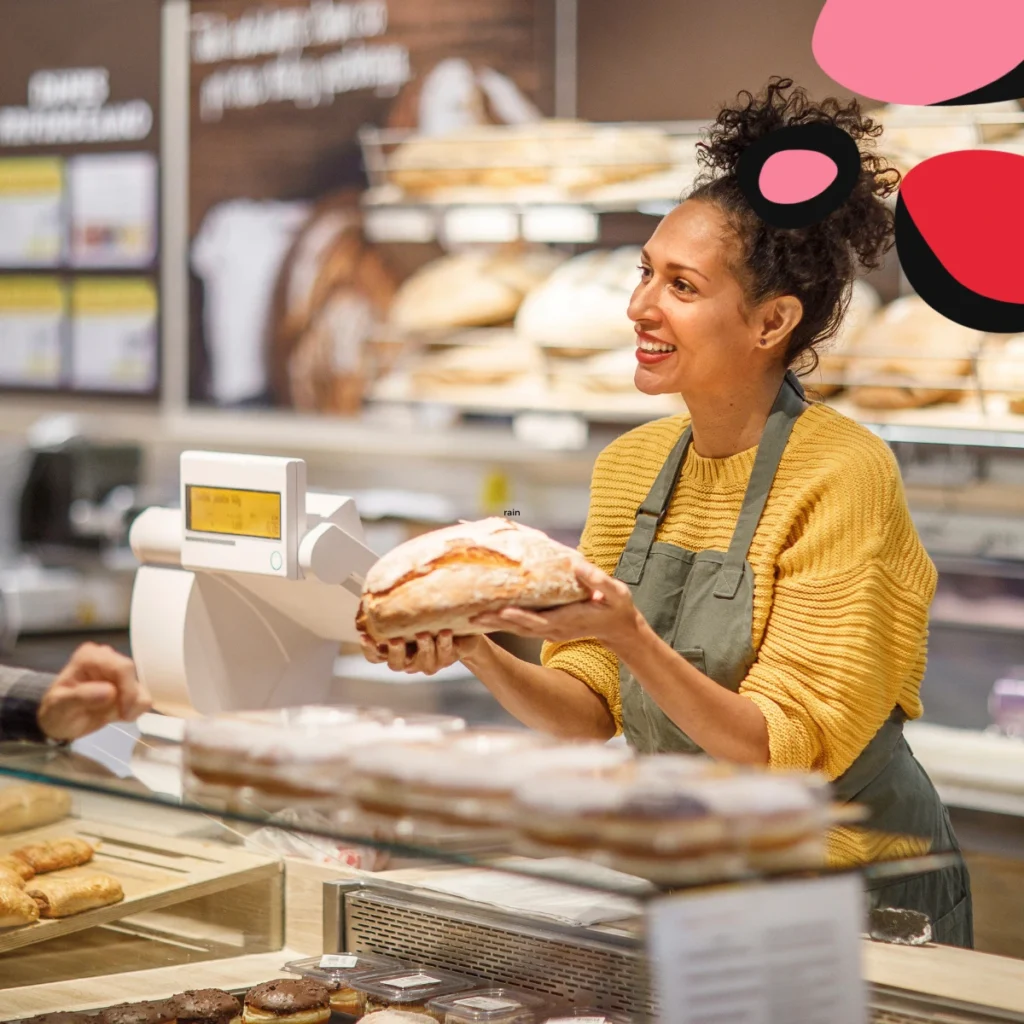 women in her bakery serving customers