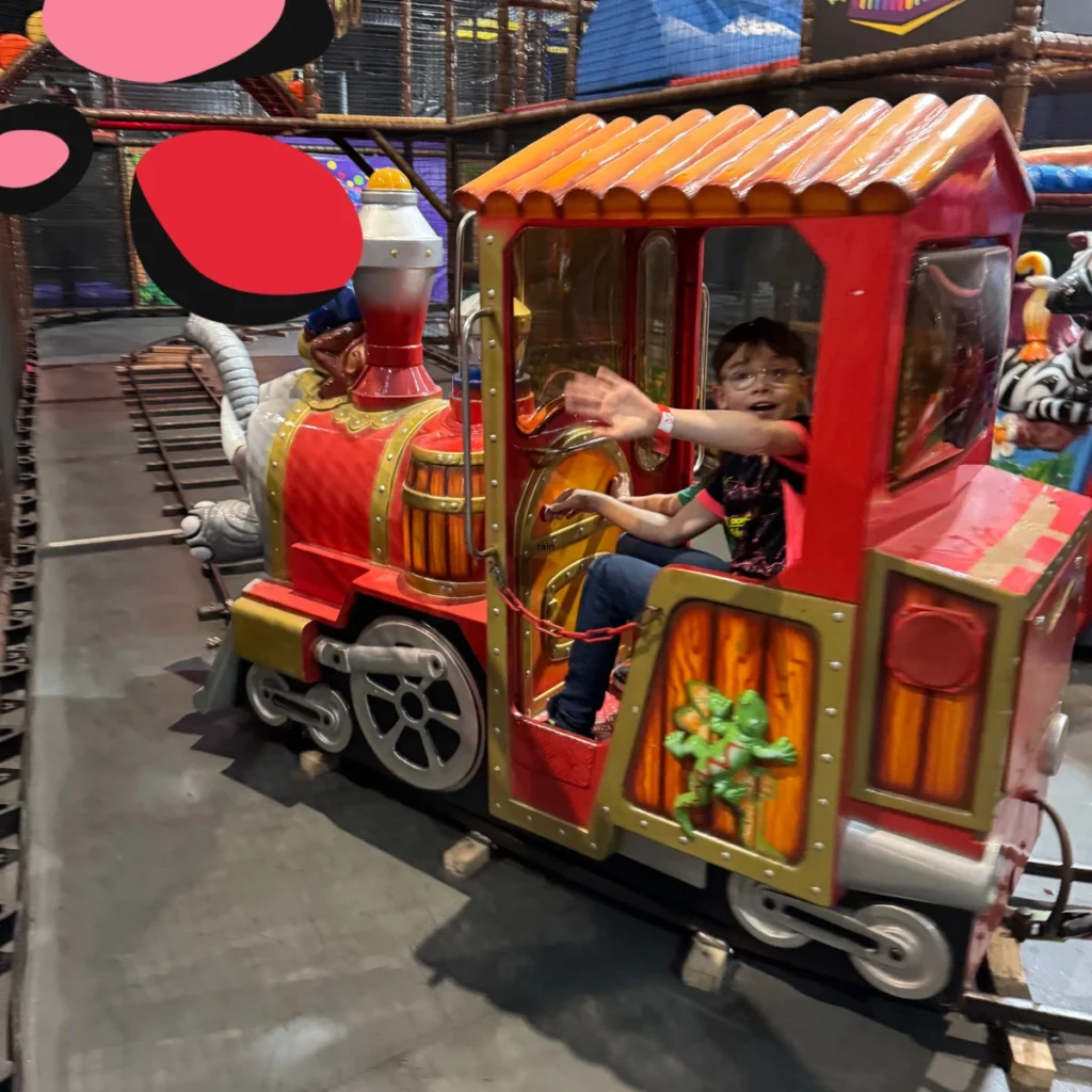 boy on the train in world of wow soft play glasgow