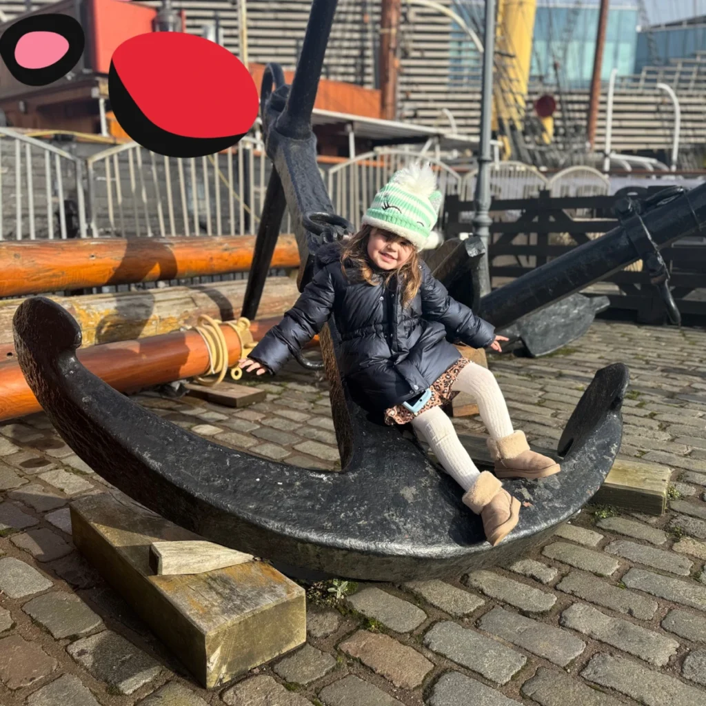little girl sat on an anchor at dundee