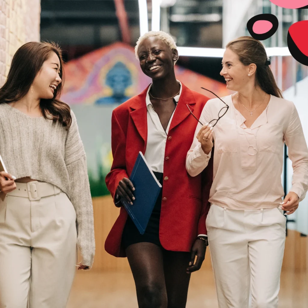 3 women happy walking down modern design office space