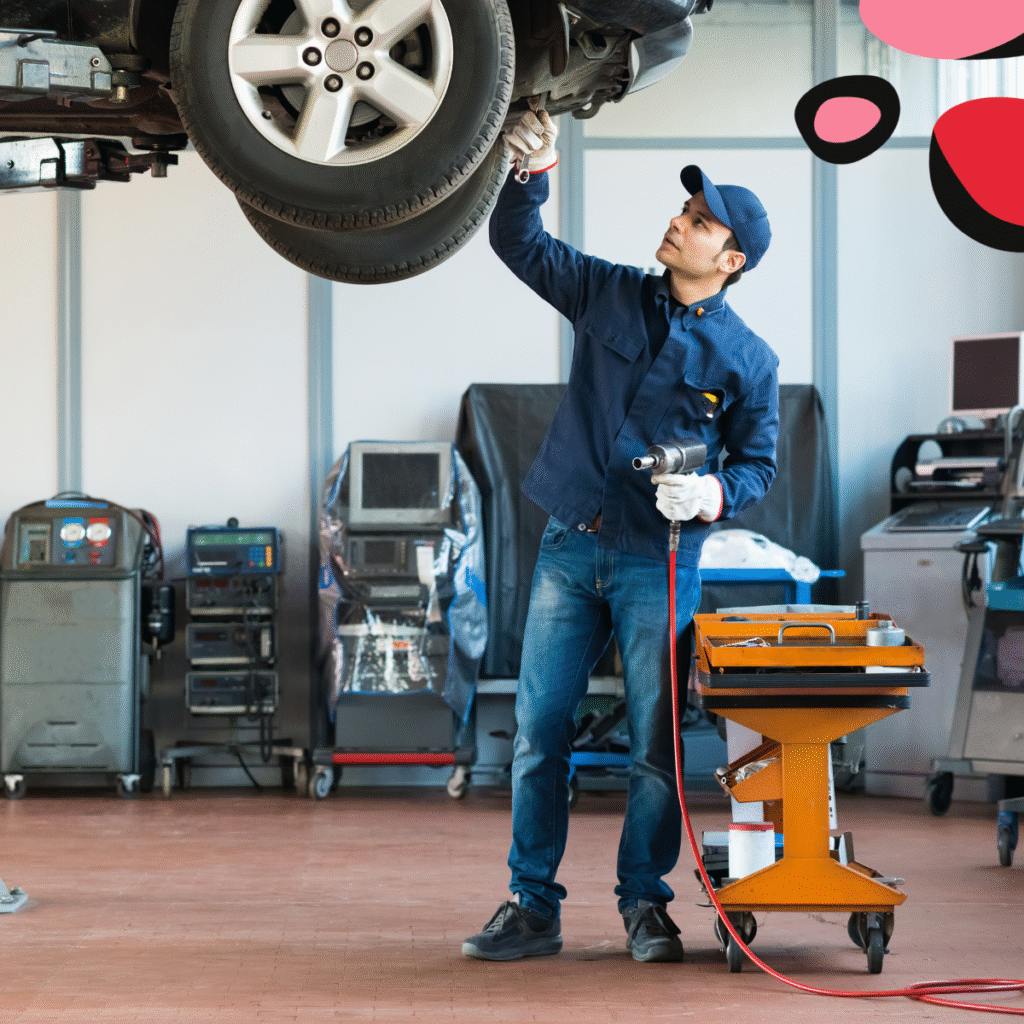 car in garage having mot with man standing under