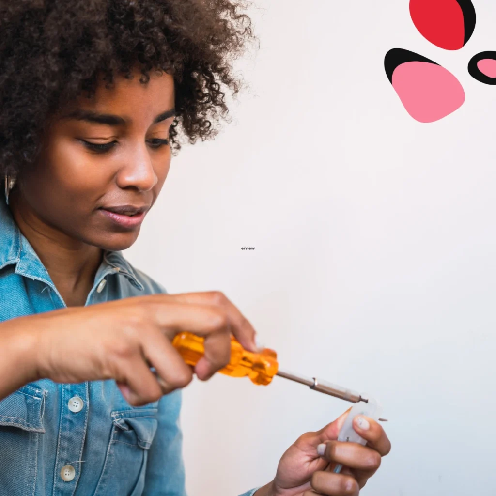 women holding a screwdriver with an orange handle in a denim shrt