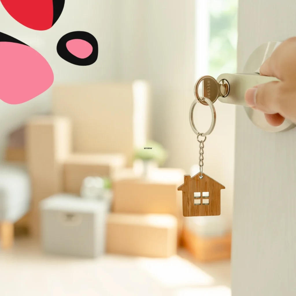 woman holding a key to a new house with boxes in the background