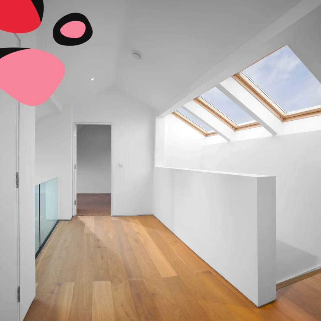 a loft conversion with white walls and light wood finishes