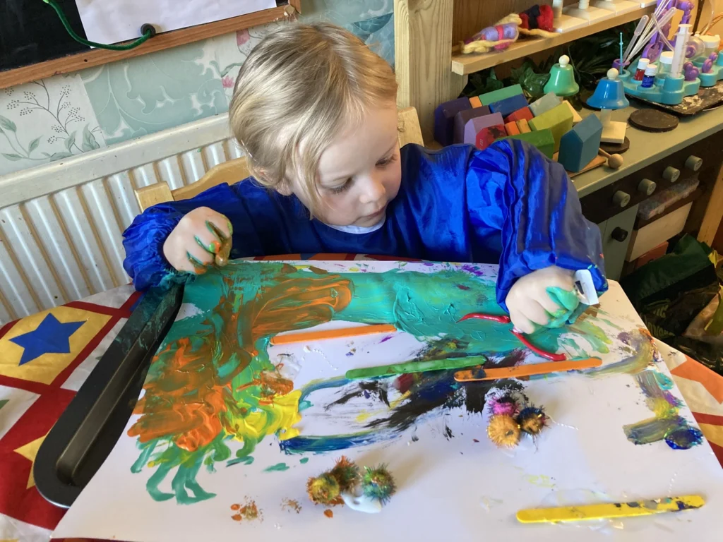 toddler with messy play using paint for Sandra Beale STEAM series