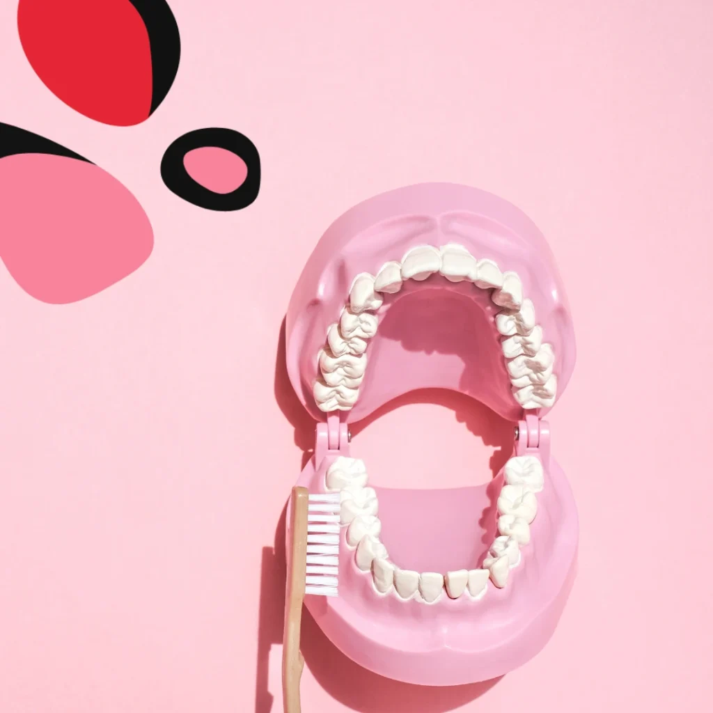 picture of teeth on a pink background with a toothbrush